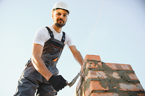 Jackson fireplace service employee performing masonry repair